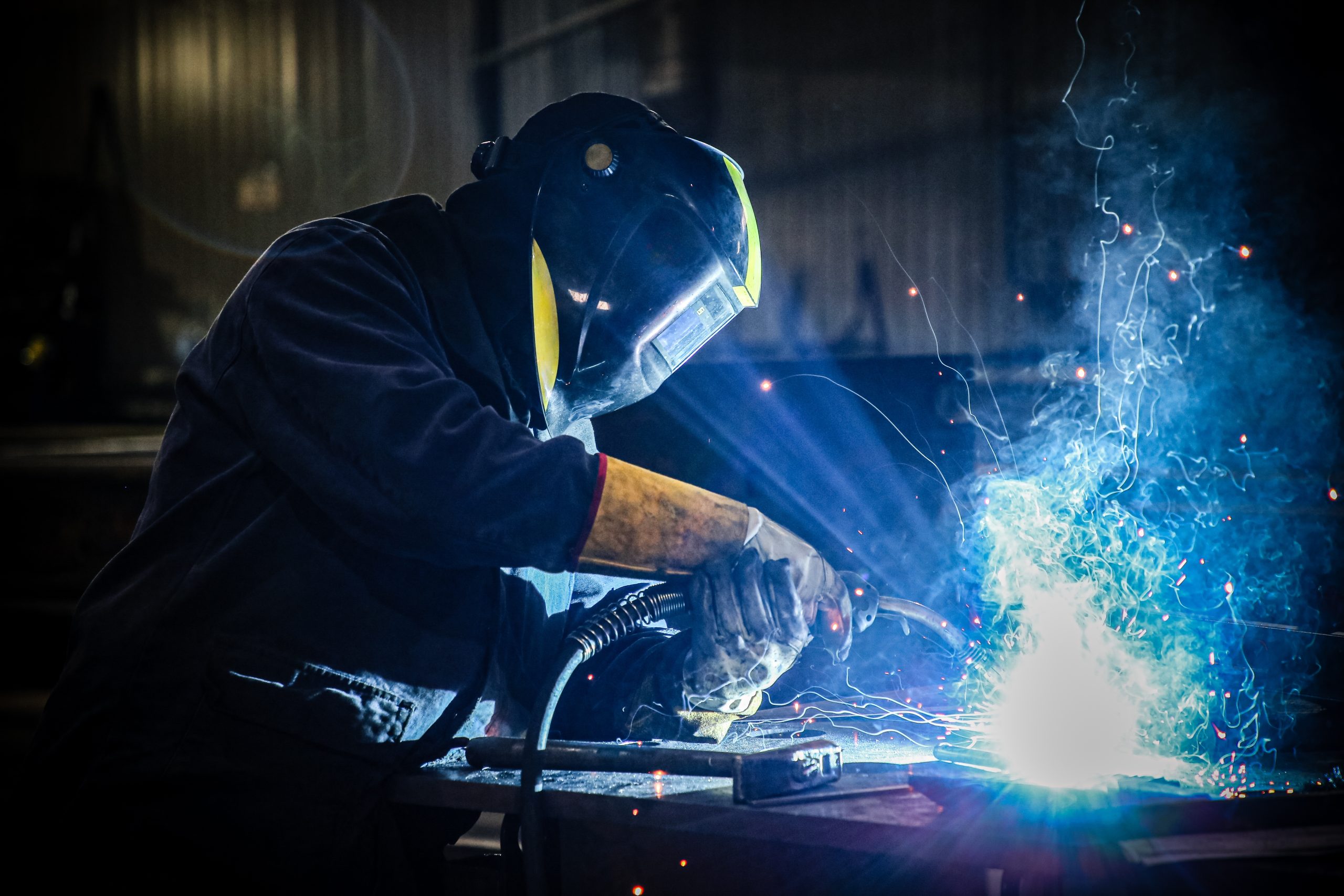 Skilled,Welder,In,Protection,At,Work,With,Sparks,Flying,In
